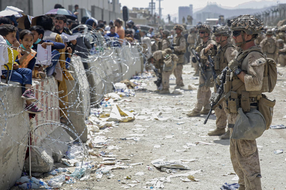 FILE - In this image provided by the U.S. Marines, U.S. Marines with Special Purpose Marine Air-Ground Task Force - Crisis Response - Central Command, provide assistance during an evacuation at Hamid Karzai International Airport in Kabul, Afghanistan, Aug. 20, 2021. The Afghan man who speaks only Farsi represented himself in U.S. immigration court, and the judge denied him asylum. The Associated Press obtained a transcript of the hearing that offers a rare look inside an opaque and overwhelmed immigration court system where hearings are closed and judges are under pressure to move quickly given the backlog of 2 million cases. (Lance Cpl. Nicholas Guevara/U.S. Marine Corps via AP, File)