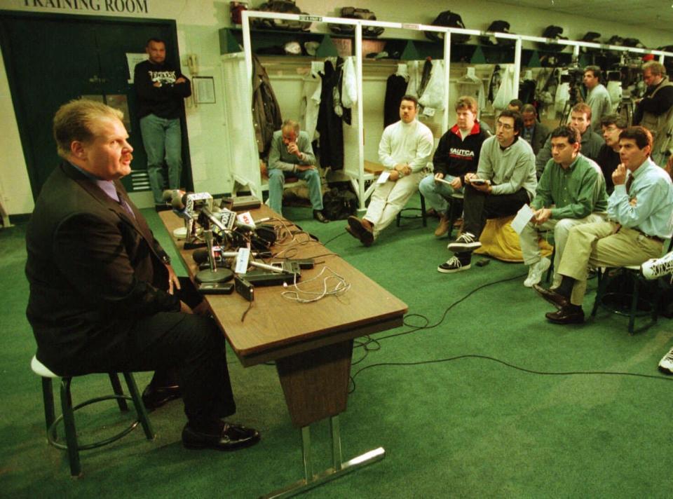 Green Bay Packers quarterback coach Andy Reid answers questions in the Philadelphia Eagles locker room after interviewing for the Eagles head coaching vacancy.