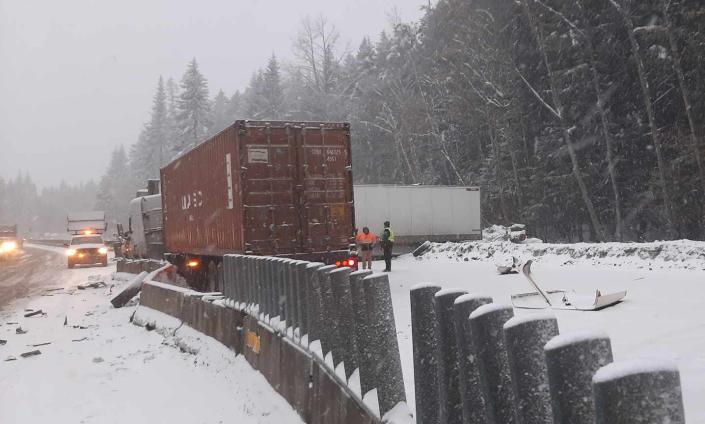 Both directions of Interstate 90 are closed after semis crashed, damaging sections of concrete barrier and pushing it from the westbound lanes into the eastbound lanes.