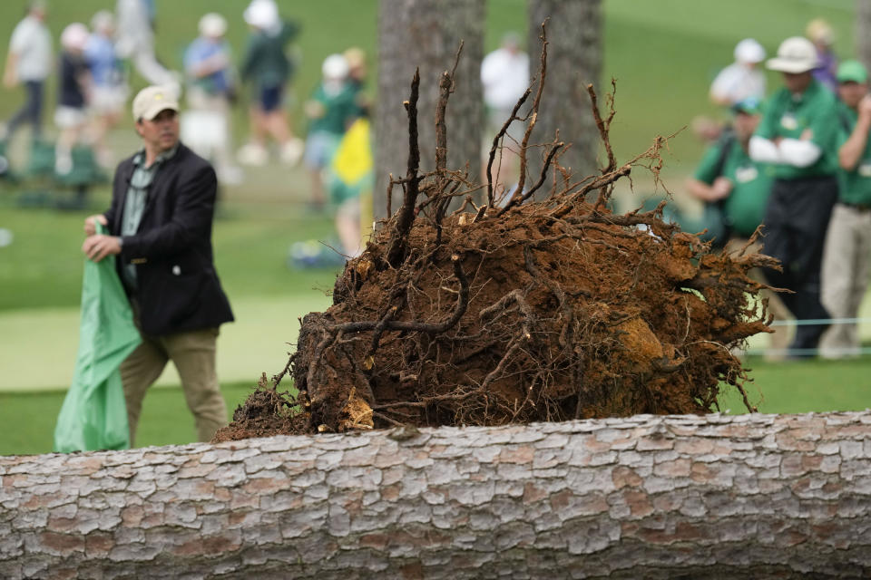 Authorities investigate the scene where trees fell on the 17th hole during the second round of the Masters golf tournament at Augusta National Golf Club on Friday, April 7, 2023, in Augusta, Ga. (AP Photo/Mark Baker)