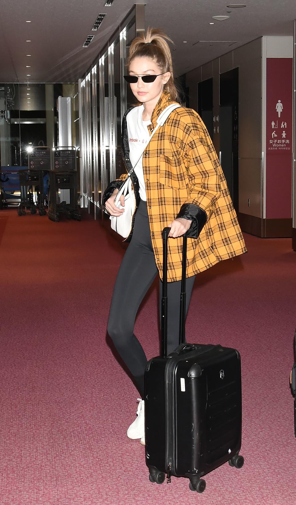When you're not feeling the denim jacket, take a tip from Gigi Hadid: A plaid blazer is just as light (and dresses up black leggings).