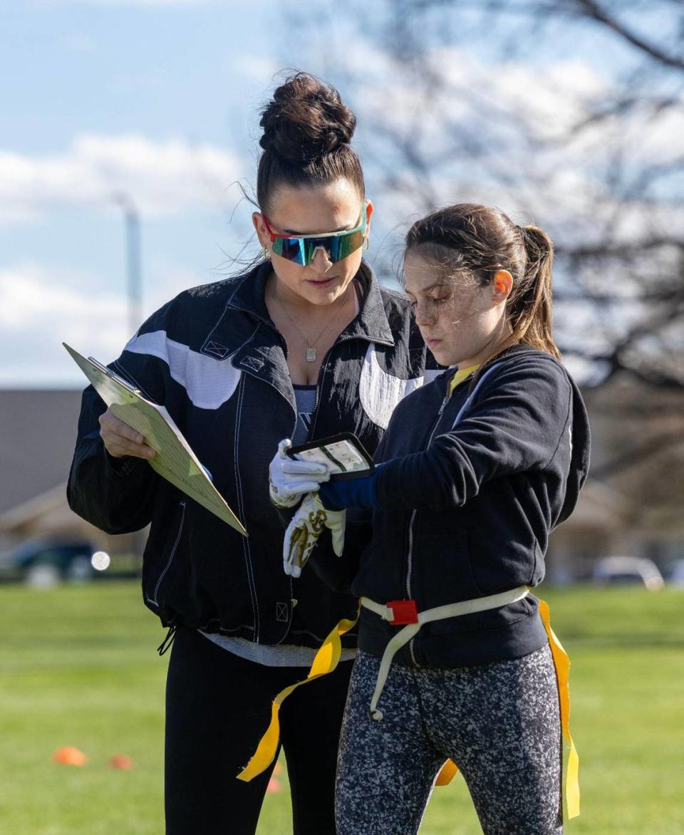 Coach Sam Hayes talks with player Makenzie Verdu, 12, during practice April 17 at Settlers Park in Meridian.