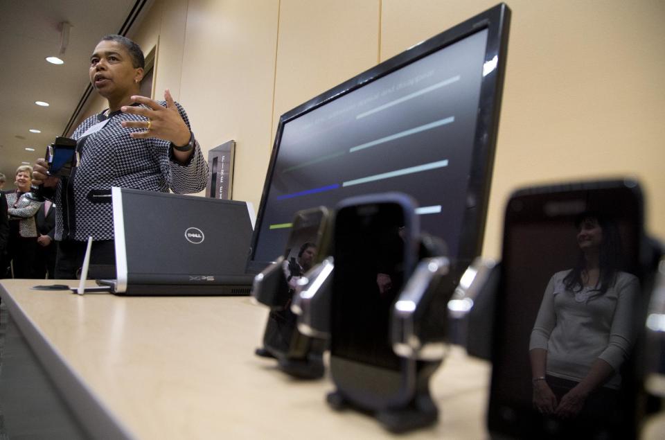 Federal Trade Commission (FTC) chief technologist Latanya Sweeney holds a cell phone as she conducts a mobile tracking demonstration, Wednesday, Feb. 19, 2014, in Washington. You might want to keep your cellphone home _ or at least turn it off _ when you go shopping. Stores are using technology to track consumers’ movements, but they say the information is anonymous. The Federal Trade Commission takes a look at the information these companies are collecting, how long they are keeping it and what it’s being used for. (AP Photo/Carolyn Kaster)