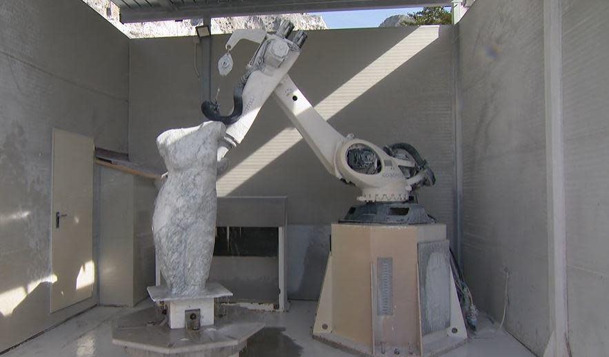 The ROBOTOR company's 1L robot sculpts a block of Carrara marble into a Venus figure, at the company's facility in Carrara, Italy.  / Credit: CBS News