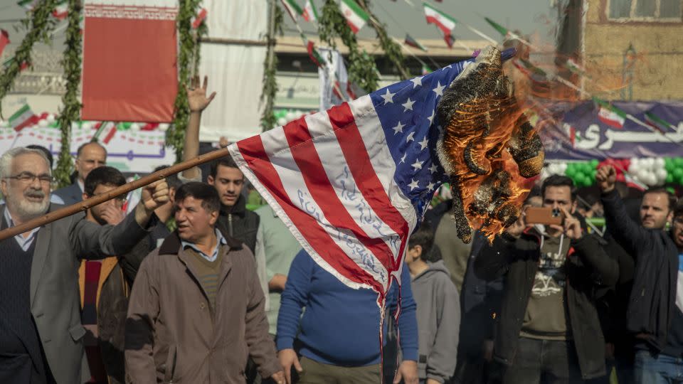 An American flag is set on fire during the annual rally commemorating Iran's 1979 Islamic Revolution in Tehran on Sunday, Feb. 11, 2024. - Majid Saeedi/Getty Images