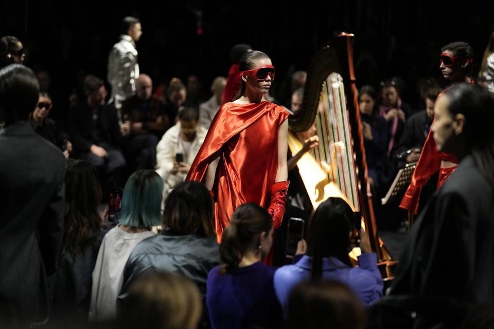 Models wear creations as part of the Ferrari women's Fall-Winter 2024-25 collection presented in Milan, Italy, Saturday, Feb. 24, 2024. (AP Photo/Antonio Calanni)