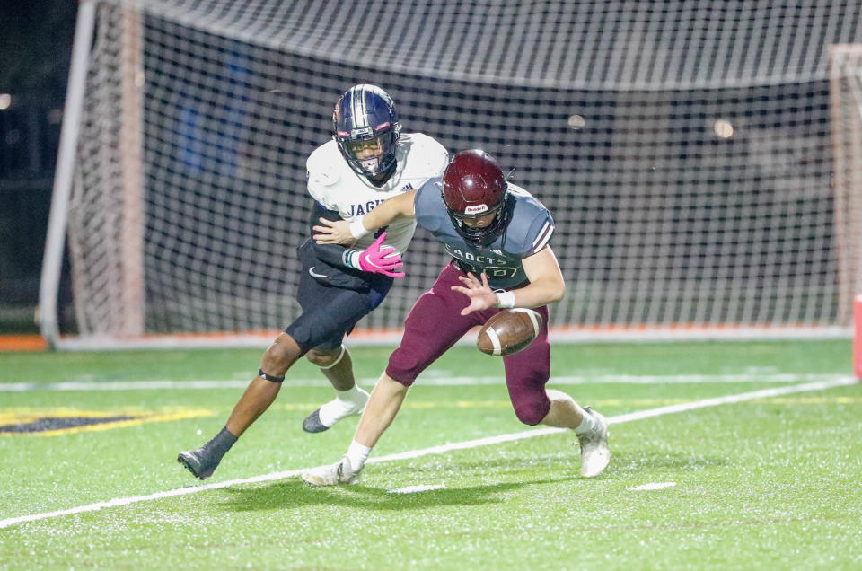 Benedictine's Joseph Stoever knocks a punt down around the 2-yard line during Friday night's state playoff game against Spalding at Memorial Stadium.