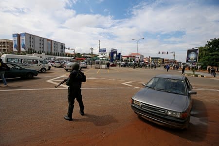 A police officer stands guard at a traffic junction along Banex road after police dispersed members of the IMN from a street in Abuja