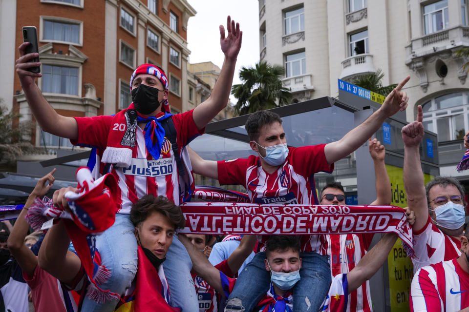 Atletico Madrid supporters celebrate their team's Spanish La Liga title in Madrid, Saturday, May 22, 2021. Atletico clinches its 11th Spanish La Liga title. (AP Photo/Paul White)