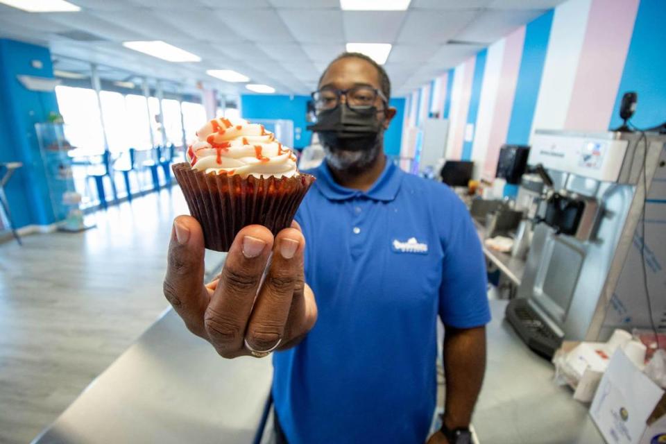 Frankie White, who’s about to open his third BW Sweets Bakery, holds a strawberry cupcake.