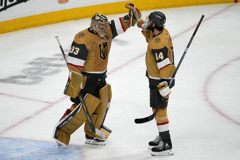 Vegas Golden Knights goaltender Adin Hill (33) and defenseman Nicolas Hague (14) celebrate after Game 2 of the NHL hockey Stanley Cup Finals against the Florida Panthers, Monday, June 5, 2023, in Las Vegas. The Golden Knights defeated the Panthers 7-2 to take a 2-0 series lead. (AP Photo/Abbie Parr)