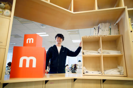 An employee of Mercari Inc. Takashi Murakami, 23, poses for a photograph at the company office in Tokyo, Japan, December 5, 2018. Picture taken December 5, 2018. REUTERS/Issei Kato