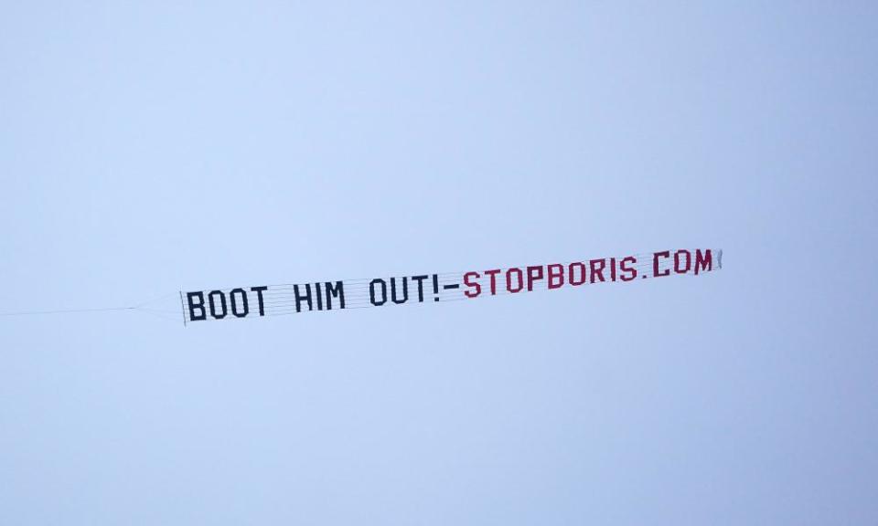 A sign protesting against Boris Johnson is flown over the Premier League match at Old Trafford, Manchester.