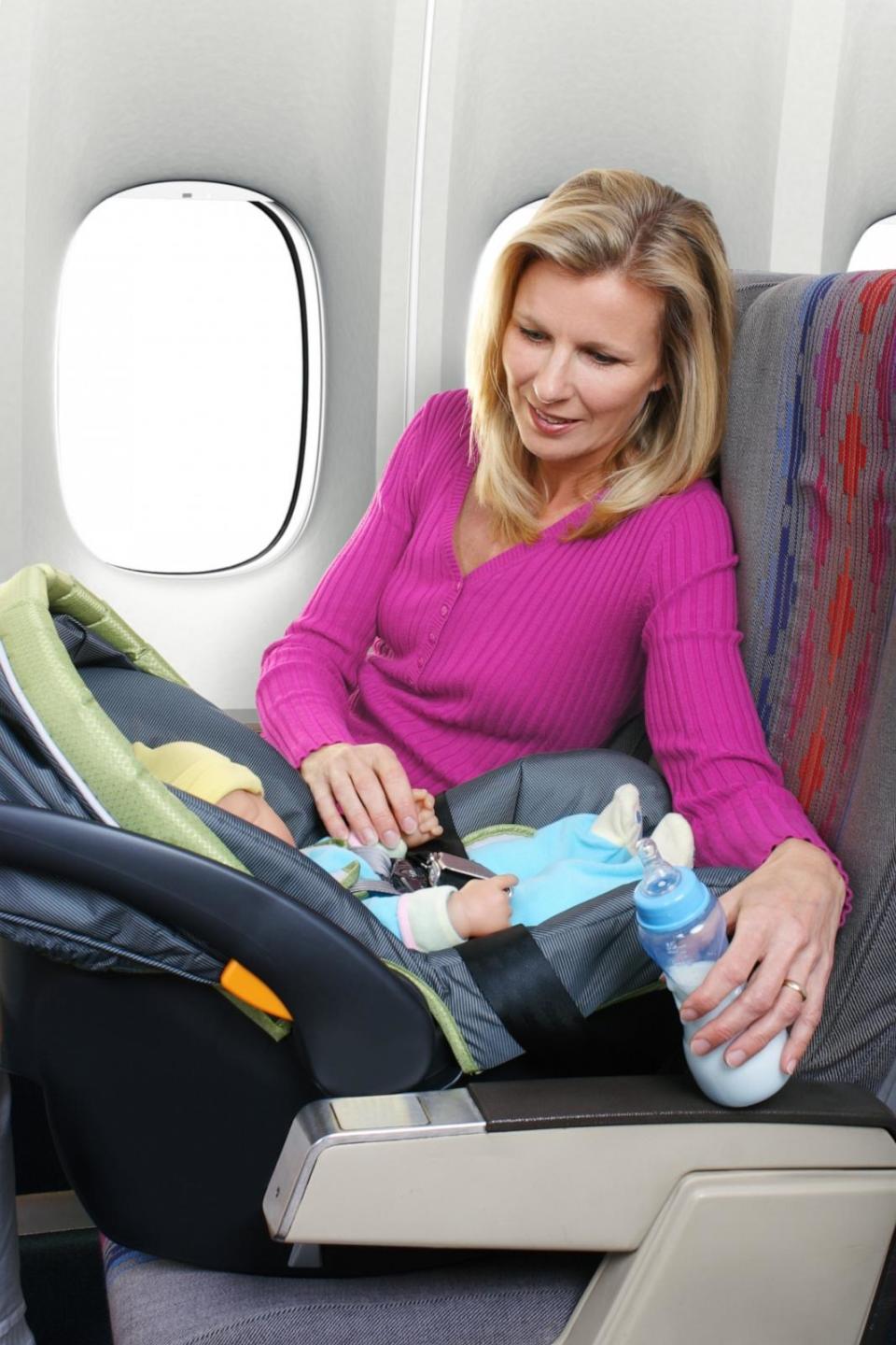 PHOTO: Mother and Baby Sitting in Airplane Seats (Gchutka/Getty Images)