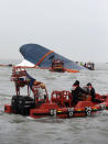 South Korean Coast Guard officers try to rescue missing passengers from a sunken ferry in the water off the southern coast near Jindo, south of Seoul, South Korea, Thursday, April 17, 2014. Fears rose Thursday for the fate of more than 280 passengers still missing more than 24 hours after their ferry flipped onto its side and filled with water off the southern coast of South Korea. (AP Photo/Yonhap) KOREA OUT