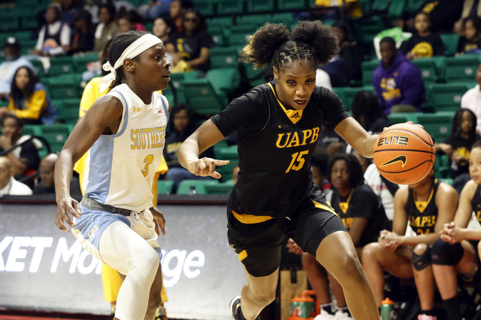 Arkansas-Pine Bluff guard Coriah Beck (15) dribbles around Southern guard Taylor Williams (3) during the second half of an NCAA college basketball game in the championship of the Southwestern Athletic Conference Tournament, Saturday, March 11, 2023, in Birmingham, Ala. (AP Photo/Butch Dill)