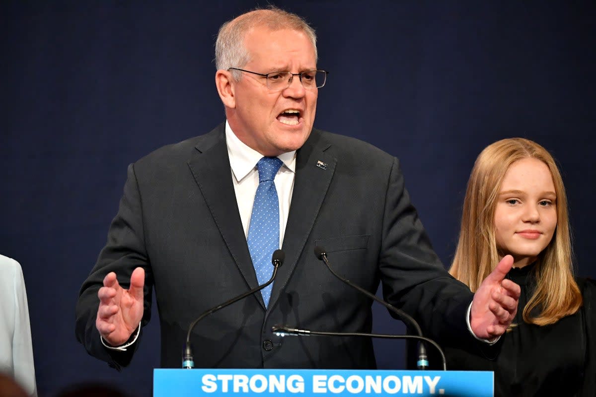 File: Australia’s prime minister Scott Morrison speaks beside his daughter at a Liberal election night after the Australian general election in Sydney on 21 May 2022 (AFP via Getty Images)