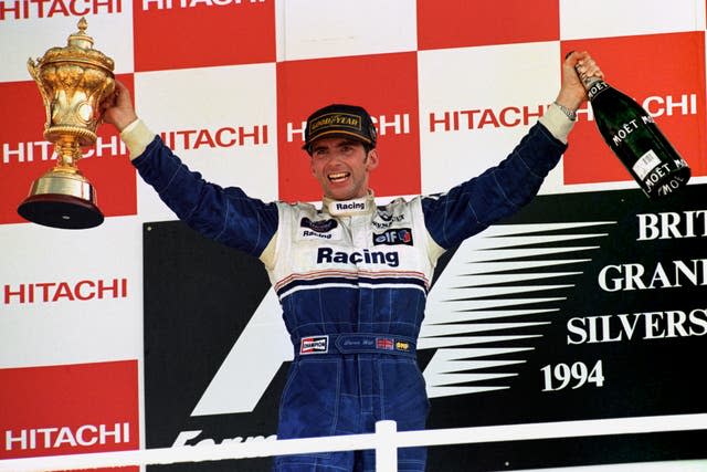 Damon Hill celebrates after winning a controversial British GP 