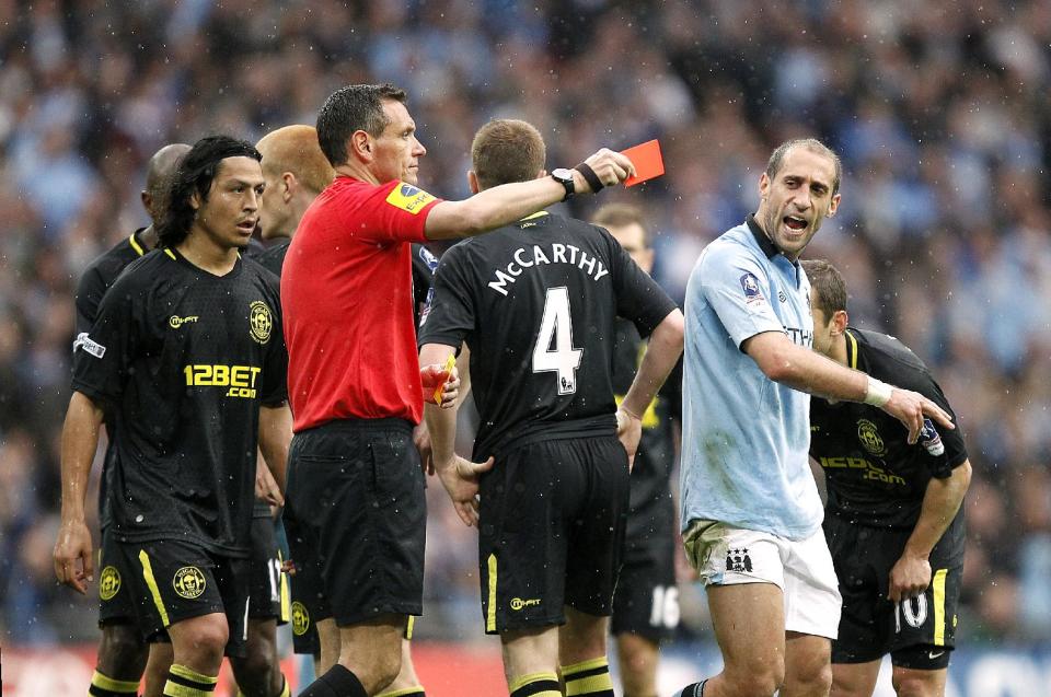 Manchester City's Pablo Zabaleta (right) is sent off by referee Andre Marriner, for a second bookeable offence, following a challenge on Wigan Athletic's Callum McManaman