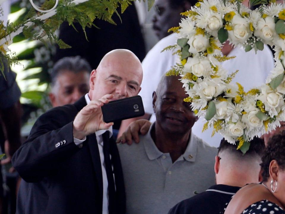 Fifa president Gianni Infantino (left) takes a selfie by Pelé’s open casket (REUTERS)