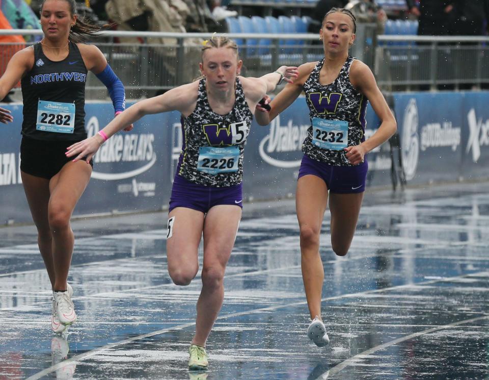 Waukee’s Anjelena Carder (front, left) and Jana Maharry (back, right) exchange the baton during high school girls 800 meter sprint medley relay at the Drake Relays on Friday in Des Moines. Carder earned two white Relays flags over the weekend.