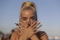 A fan strikes a pose as she waits for the start of Madonna's last show of her The Celebration Tour, on Copacabana beach in Rio de Janeiro, Brazil, Saturday, May 4, 2024. (AP Photo/Bruna Prado)