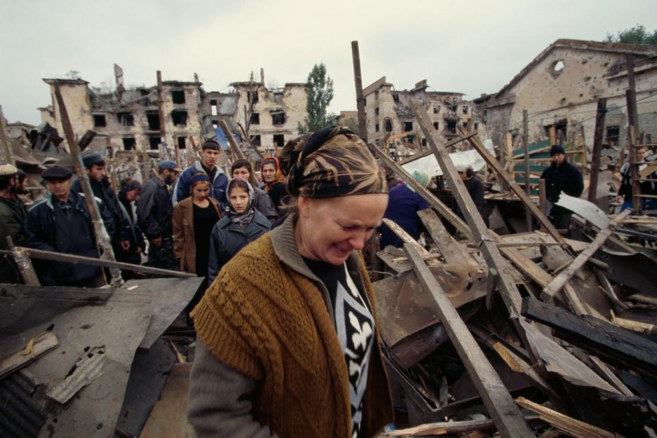 Civilians come back to the main Grozny market after its destruction by a Russian missile, Chechnya in 1999. (Antoine GYORI/Sygma via Getty Images)