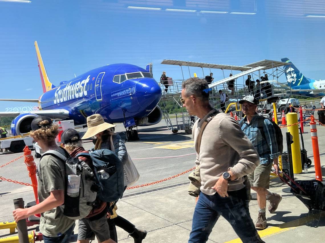 A Southwest Airlines 737-800 waits at the gate as passengers head toward the terminal at Bellingham (Wash.) International Airport after a flight from Las Vegas on June 28, 2023. Robert Mittendorf/The Bellingham Herald