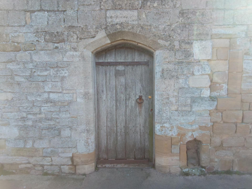 Old wooden door set into brickwork