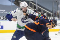 Edmonton Oilers' Darnell Nurse (25) and Vancouver Canucks' Zack MacEwen (71) fight during the third period of an NHL hockey game Thursday, May, 6, 2021, in Edmonton, Alberta. (Jason Franson/The Canadian Press via AP)