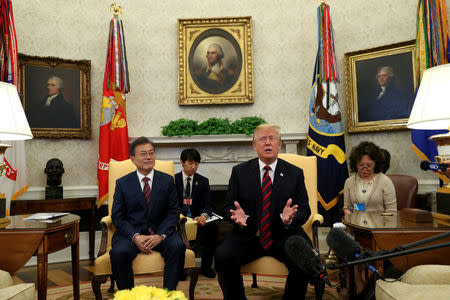 U.S. President Donald Trump welcomes South Korea's President Moon Jae-In in the Oval Office of the White House in Washington, U.S., May 22, 2018. REUTERS/Kevin Lamarque
