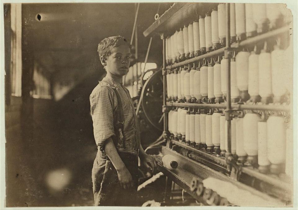 John Dempsey, said to be 12 years old, working in the mule-spinning room at Jackson Mill, Fiskeville, R.I. in 1909.