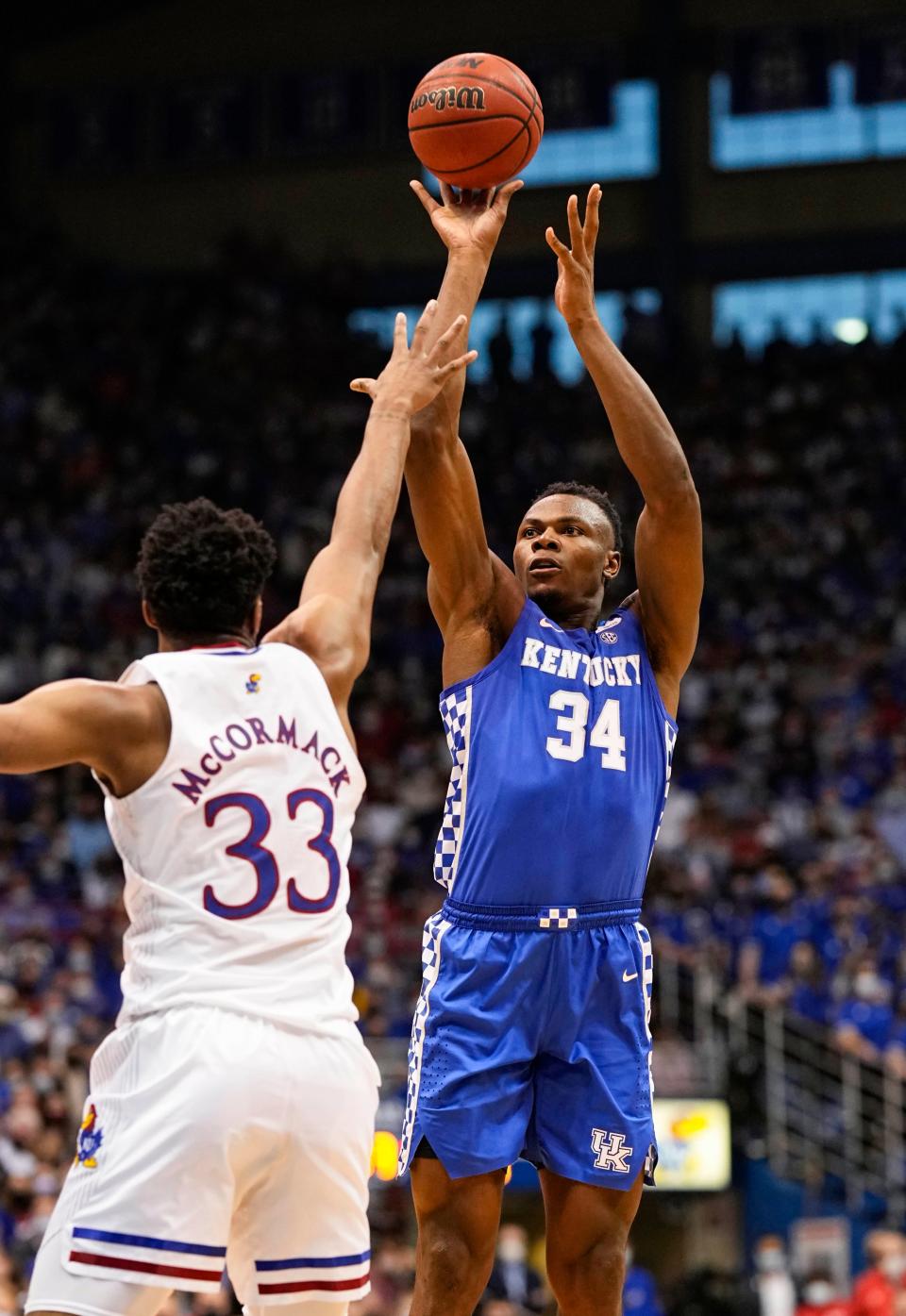 Jan 29, 2022; Lawrence, Kansas, USA; Kentucky Wildcats forward Oscar Tshiebwe (34) shoots over Kansas Jayhawks forward David McCormack (33) during the first half at Allen Fieldhouse. Mandatory Credit: Jay Biggerstaff-USA TODAY Sports