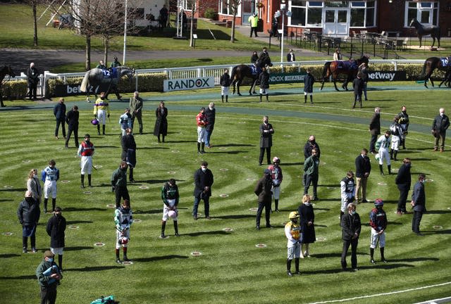 Racegoers and riders at Aintree observe a two-minute silence for the late Prince Philip, Duke of Edinburgh 
