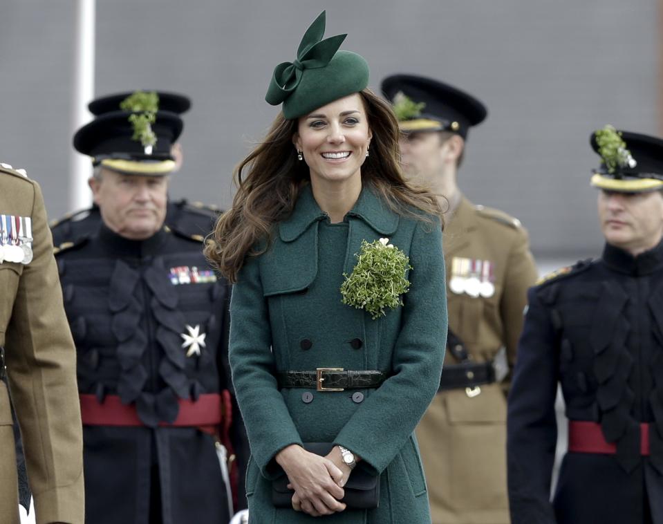 Kate, The Duchess of Cambridge smiles during a visit to the 1st Battalion Irish Guards at the St. Patrick's Day Parade at Mons Barracks, Aldershot, in England, Monday, March 17, 2014. The Duke of Cambridge attended the Parade as Colonel of the Regiment. The Duchess of Cambridge presented the traditional sprigs of shamrocks to the Officers and Guardsmen of the Regiment. (AP Photo/Kirsty Wigglesworth)