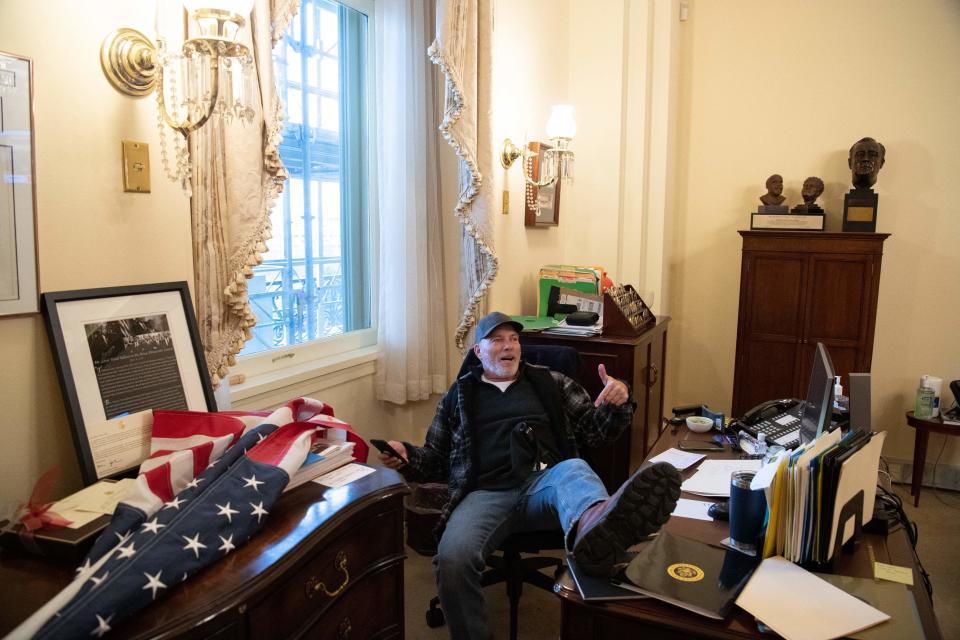 Richard Barnett inside the office of House Speaker Nancy Pelosi during the attack on the U.S. Capitol on Jan. 6, 2021. / Credit: SAUL LOEB/AFP via Getty Images