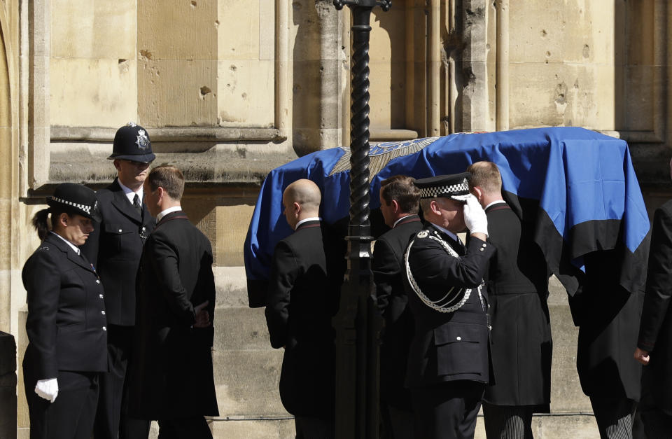 A coffin carrying the late PC Keith Palmer, who was killed in the London attack on March 22, is carried into the Houses of Parliament to rest overnight in the Chapel of St Mary Undercroft in London, Sunday, April 9, 2017. Palmer's funeral is due to take place at Southwark Cathedral in London on Monday. (AP Photo/Matt Dunham)