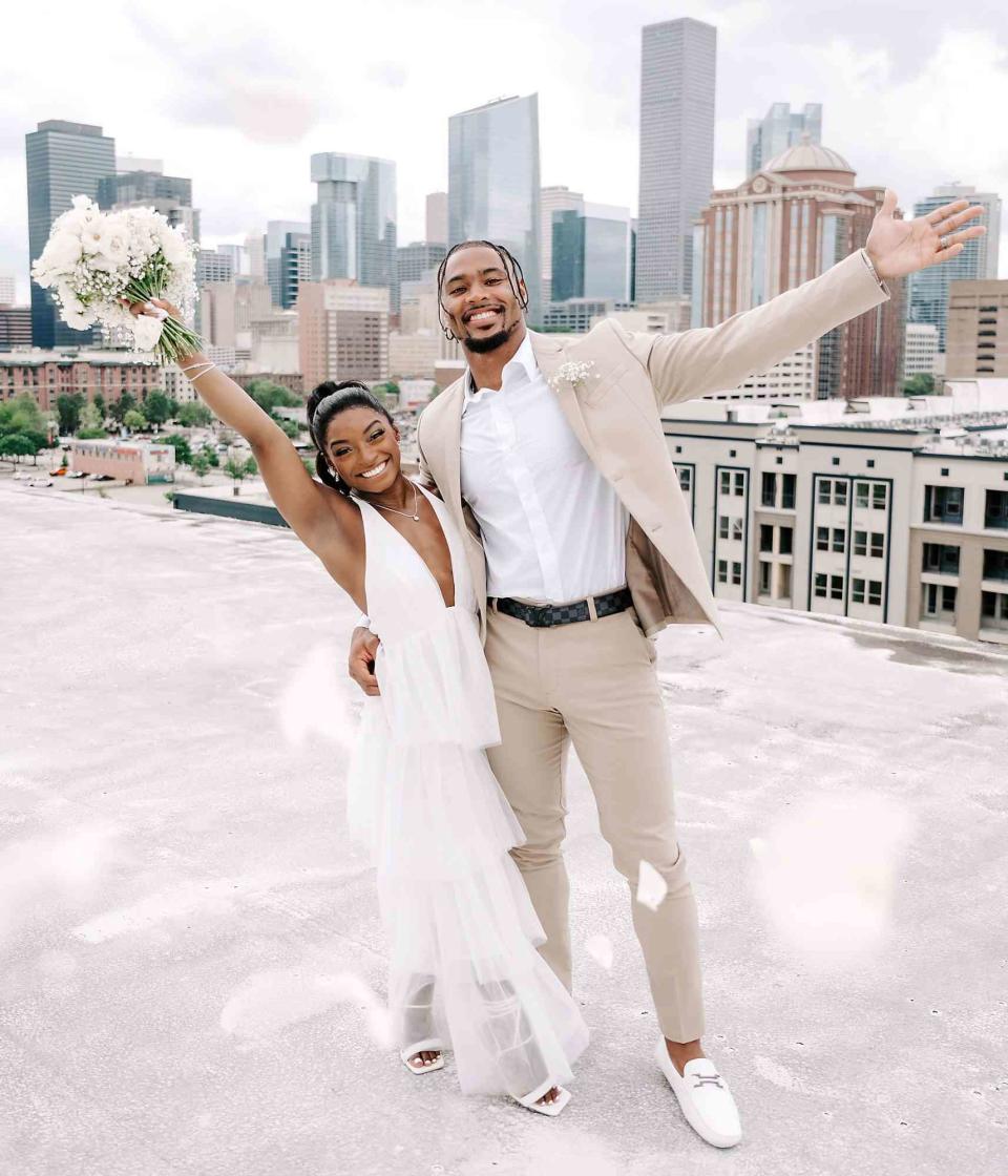 RAETAY PHOTOGRAPHY Simone Biles poses with bouquet alongside husband Jonathan Owens on their wedding day in April 2023.