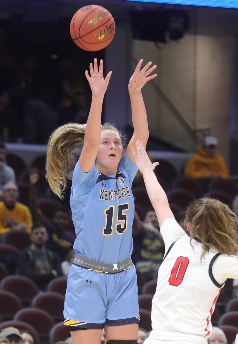 Kent State's Bridget Dunn puts up a 3-point shot over Ball State's Ally Becki in a MAC Tournament semifinal Friday in Cleveland.