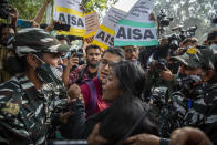 FILE- In this Feb. 16, 2021 file photo, paramilitary soldiers try to stop students protesting against the police action against various activists in New Delhi, India. Disha Ravi, a 22-year-old climate activist in India, was arrested and charged with sedition last month for sharing an online handbook meant to help raise support for farmer protests that have convulsed India. Although she was granted bail after 10 days in custody, the case hit home for a lot of Indians who now fear they could be jailed for simply sharing views on social media. Criminal lawyers point to a troubling frequency in the way sedition, a colonial-era law, is invoked. (AP Photo/Altaf Qadri, File)