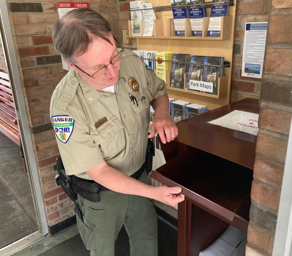 Bryan Hogan, Presque Isle State Park ranger supervisor, checks the lost and found drop box located at the park's police and safety building across from Beach 6.