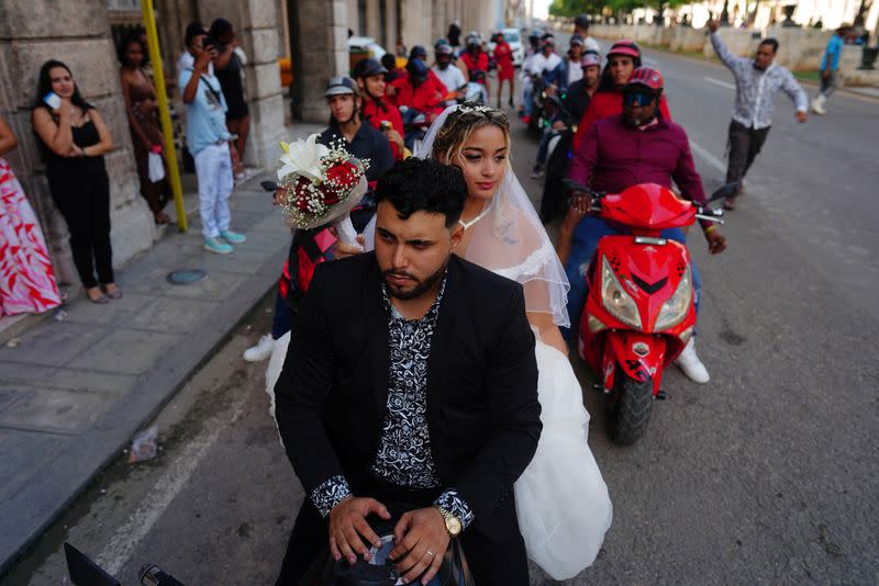 Bride and groom opt for electric motorcycles instead of limos amidst fuel shortage in Cuba