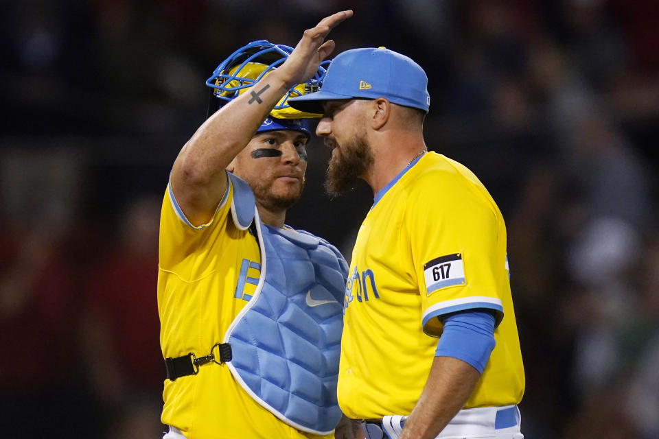 Boston Red Sox relief pitcher John Schreiber, right, is congratulated by catcher Christian Vazquez after earning the save in a 5-4 win over the Detroit Tigers during a baseball game, Tuesday, June 21, 2022, at Fenway Park in Boston. (AP Photo/Charles Krupa)