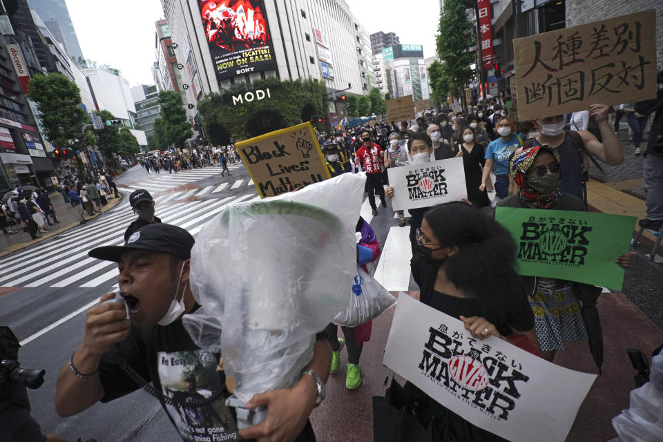 People march to protest during a solidarity rally for the death of George Floyd in Tokyo Sunday, June 14, 2020. Floyd died after being restrained by Minneapolis police officers on May 25. (AP Photo/Eugene Hoshiko)