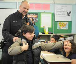 A photograph of District Chief Jeffrey Bacon from January 2018 during a student coat drive at Watson Elementary.