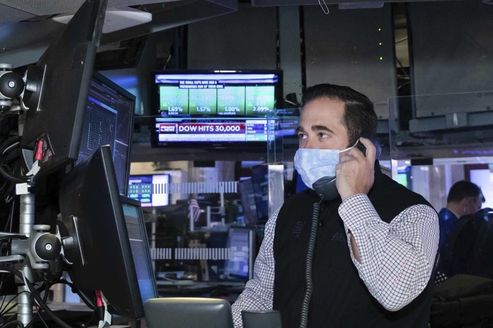 A trader at the New York Stock Exchange works at his terminal, Tuesday, November 24, 2020. The Dow Jones Industrial Average traded above 30,000 points for the first time as investors were encouraged by the latest progress on developing coronavirus vaccines and news that the transition of power in the U.S. to President-elect Joe Biden will finally begin. (Nicole Pereira/NYSE via AP)