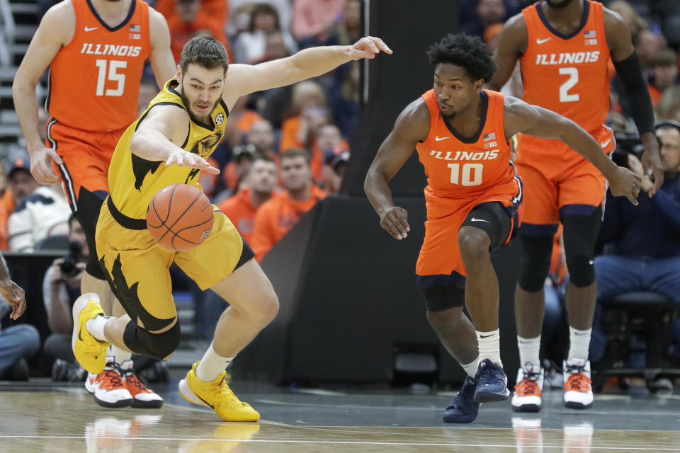 Missouri's Reed Nikko, left, and Illinois' Andres Feliz (10) chase a loose ball during the first half of an NCAA college basketball game Saturday, Dec. 21, 2019, in St. Louis. (AP Photo/Jeff Roberson)