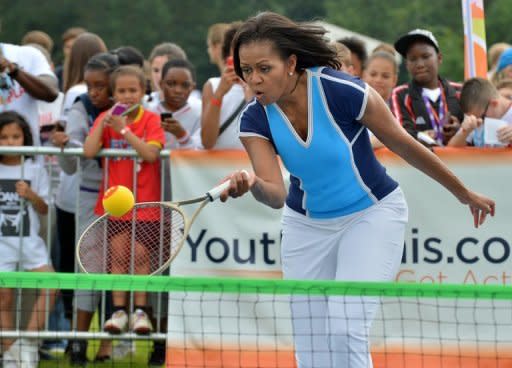 US First Lady Michelle Obama plays tennis during the "Let's Move-London" event in London on July 27. With charm, hidden steel and growing political skill, First Lady Michelle Obama is injecting a timely jolt of verve into her husband's battered political brand