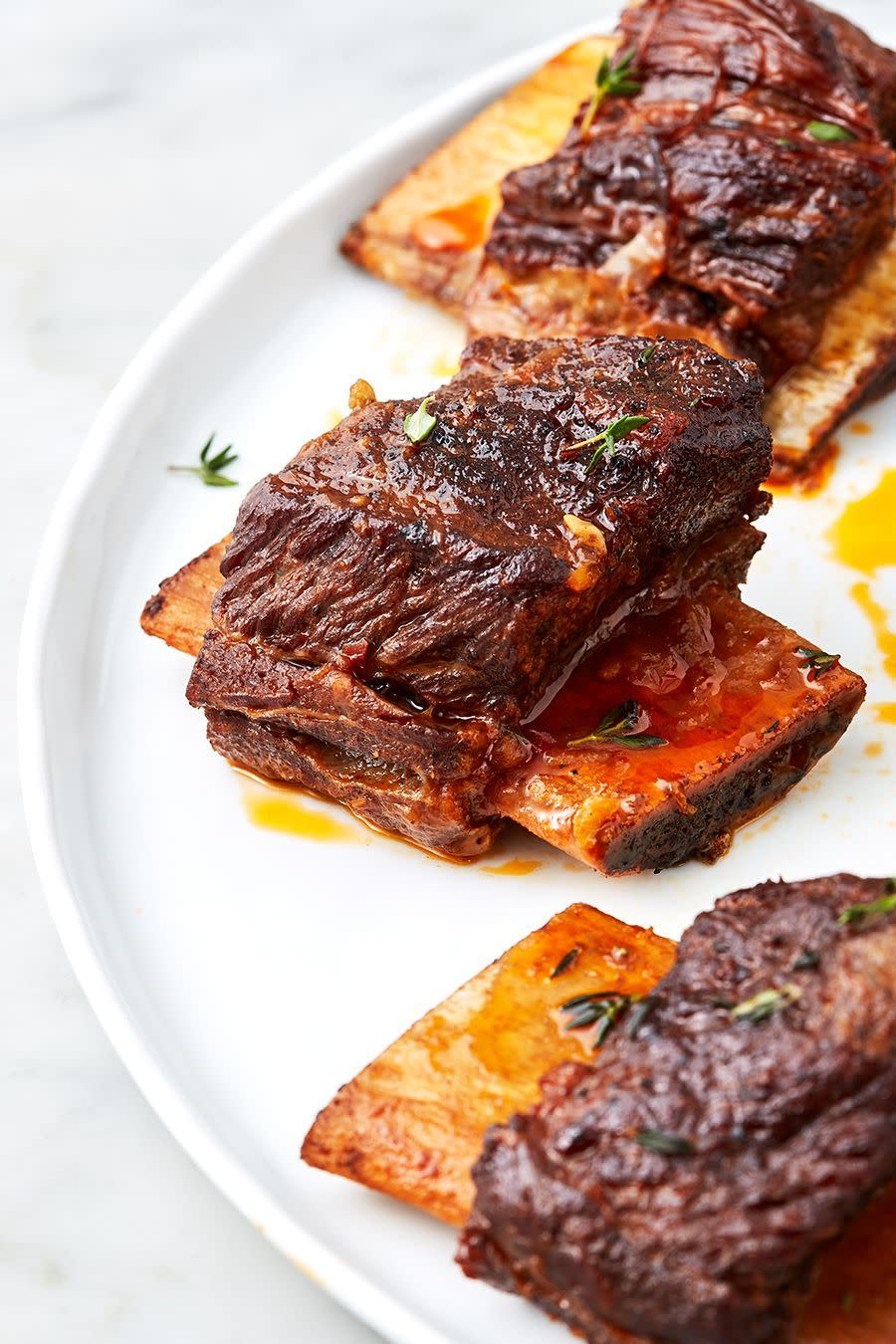 <p>While not exactly instant, this Instant Pot recipe takes half the time most braised ribs recipes call for. The richness of bacon and short ribs shines against the mildly sweet background of sherry wine, carrots, and star anise. </p><p>Get the <a href="https://www.delish.com/uk/cooking/recipes/a31389371/instant-pot-short-ribs-recipe/" rel="nofollow noopener" target="_blank" data-ylk="slk:Instant Pot Short Ribs;elm:context_link;itc:0;sec:content-canvas" class="link ">Instant Pot Short Ribs</a> recipe.</p>