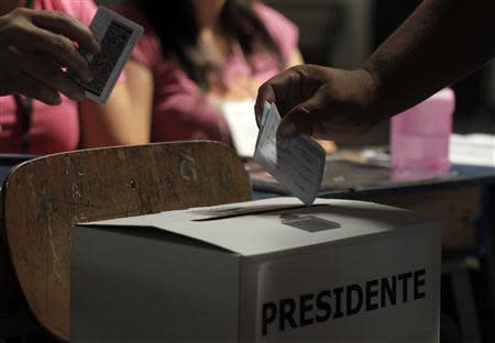 A voter casts a vote at a polling station during Costa Rica's presidential election run-off in San Jose April 6, 2014. REUTERS/Juan Carlos Ulate